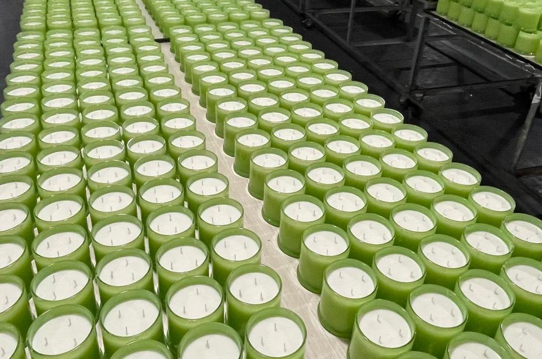 A variety of private label candles with different labels and scents
