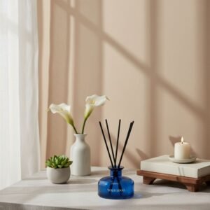 Blue glass reed diffuser on cozy table